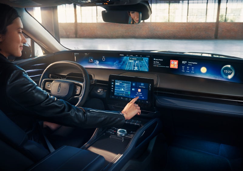 The driver of a 2024 Lincoln Nautilus® SUV interacts with the center touchscreen. | West Point Lincoln in Houston TX